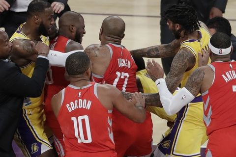 Houston Rockets' Chris Paul, second from left, is held back by Los Angeles Lakers' LeBron James, left, as Paul fights with Lakers' Rajon Rondo, center obscured, during the second half of an NBA basketball game Saturday, Oct. 20, 2018, in Los Angeles. The Rockets won, 124-115. (AP Photo/Marcio Jose Sanchez)