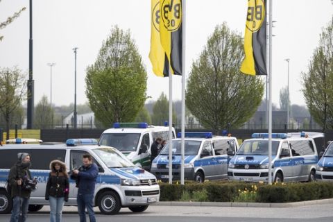 Police cars park outside the training grounds of Borussia Dortmund in Dortmund, Germany, Wednesday, April 12, 2017, the day after the team bus was damaged in an explosion which injured a player and a police officer. (Marius Becker/dpa via AP)