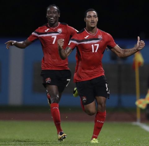 Trinidad and Tobago's Alvin Jones (17) celebrates with teammate Nathan Lewis after scoring against U.S. during a World Cup qualifying soccer match in Couva, Trinidad, Tuesday, Oct. 10, 2017. (AP Photo/Rebecca Blackwell)