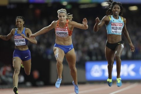 Netherlands' Dafne Schippers, center, dips to win the gold in the Women's 200m final during the World Athletics Championships in London Friday, Aug. 11, 2017. (AP Photo/David J. Phillip)