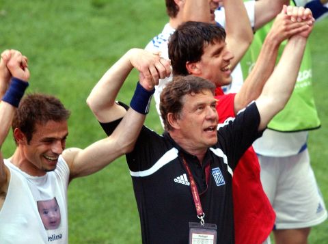 Greece coach Otto Rehhagel of Germany, center, celebrates with his players after they drew 1-1 with Greece during their Euro 2004, Group A, soccer match at the Bessa stadium in Porto, Portugal, Wednesday, June 16, 2004. The other teams in Group A are Portugal and Russia. (AP Photo/Luca Bruno) **  FOR EDITORIAL USE ONLY NO WIRELESS COMMERCIAL OR PROMOTIONAL LICENSING PERMITTED  **