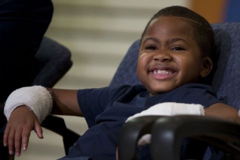 Double-hand transplant recipient eight-year-old Zion Harvey smiles during a news conference Tuesday, July 28, 2015, at The Childrens Hospital of Philadelphia (CHOP) in Philadelphia. Surgeons said Harvey of Baltimore who lost his limbs to a serious infection,  has become the youngest patient to receive a double-hand transplant. (AP Photo/Matt Rourke)