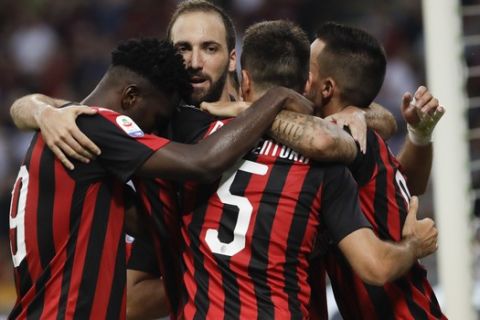 AC Milan's Giacomo Bonaventura, center, celebrates with his teammates Suso, right, Gonzalo Higuain and Franck Kessie after scoring his side's 2nd goal during a Serie A soccer match between AC Milan and Atalanta, at the San Siro stadium in Milan, Italy, Sunday, Sept. 23, 2018. (AP Photo/Luca Bruno)