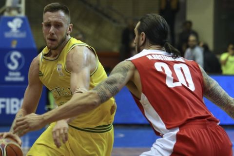 Australia's Mitch Creek, left, drives to the basket as Iran's Michael Rostampour defends during their Asian qualifying basketball match for World Cup 2019, at Azadi sports compound, in Tehran, Iran, Sunday, Feb. 24, 2019. (AP Photo/Vahid Salemi)