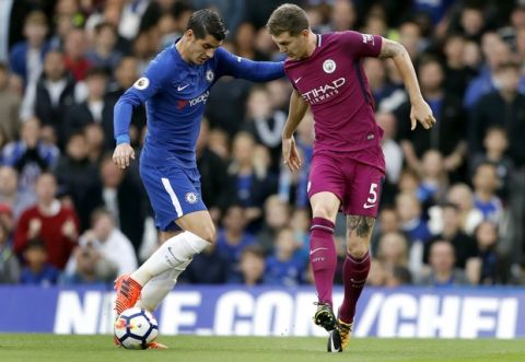 Chelsea's Alvaro Morata, left, and Manchester City's John Stones, right, challenge for the ball during their English Premier League soccer match between Chelsea and Manchester City at Stamford Bridge stadium in London, Saturday, Sept. 30, 2017. (AP Photo/Frank Augstein)