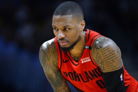 Portland Trail Blazers guard Damian Lillard looks on during a foul shot in the first half of Game 7 of an NBA basketball second-round playoff series against the Denver Nuggets Sunday, May 12, 2019, in Denver. (AP Photo/John Leyba)