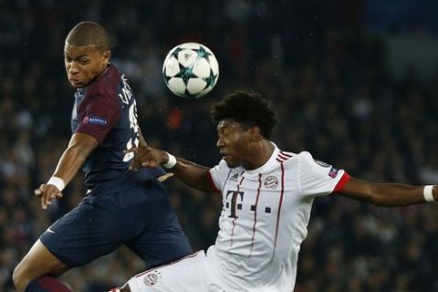 Bayern's David Alaba, right, and PSG's Kylian Mbappe challenge for the ball during the Champions League Group B soccer match between Paris Saint-Germain and Bayern Munich in Paris, France, Wednesday, Sept. 27, 2017. (AP Photo/Thibault Camus)