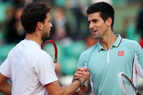 PARIS, FRANCE - JUNE 01:  Novak Djokovic of Serbia shakes hands at the net with his opponent Grigor Dimitrov of Bulgaria after their Men's Singles match on day seven of the French Open at Roland Garros on June 1, 2013 in Paris, France.  (Photo by Clive Brunskill/Getty Images)
