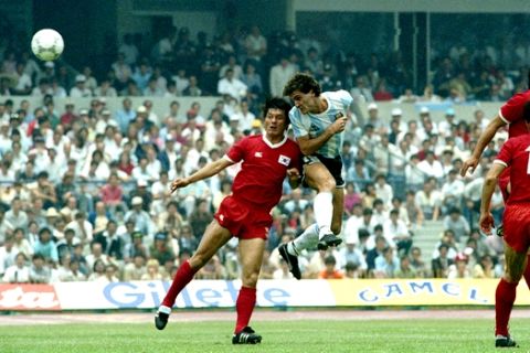 Oscar Alfredo Ruggeri of Argentina, vainly guarded by South Korea's Jong-Hwan Jung, heads the ball to score the second goal for his team in their World Cup game, June 2, 1986, in Mexico City.  (AP Photo)