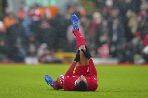 Liverpool's Joel Matip lies on the pitch in pain during the English Premier League soccer match between Liverpool and Fulham at the Anfield stadium in Liverpool, England, Sunday, Dec. 3, 2023. (AP Photo/Jon Super)