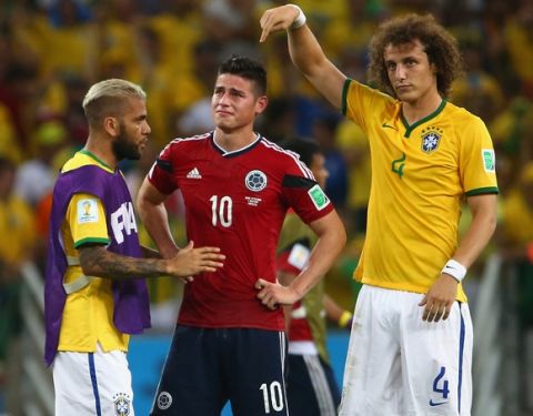 FORTALEZA, BRAZIL - JULY 04:  Dani Alves (L) and David Luiz of Brazil console James Rodriguez of Colombia after Brazil's 2-1 win during the 2014 FIFA World Cup Brazil Quarter Final match between Brazil and Colombia at Castelao on July 4, 2014 in Fortaleza, Brazil.  (Photo by Robert Cianflone/Getty Images)