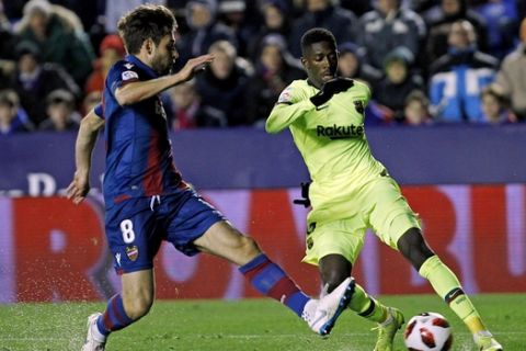 Barcelona forward Ousmane Dembele, right, duels for the ball with Levante midfielder Prcic during the la Copa del Rey round of 16 first leg soccer match between Levante and Barcelona at the Ciutat de Valencia stadium in Valencia, Spain, Thursday Jan. 10, 2019. (AP Photo/Alberto Saiz)