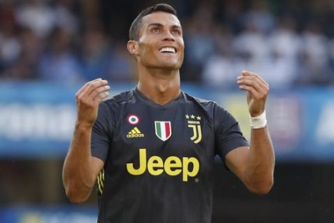 Juventus' Cristiano Ronaldo runs with the ball during the Serie A soccer match between Chievo Verona and Juventus, at the Bentegodi Stadium in Verona, Italy, Saturday, Aug. 18, 2018. (AP Photo/Antonio Calanni)