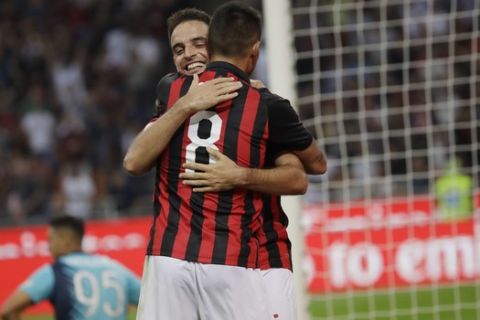AC Milan's Giacomo Bonaventura, right, celebrates with his teammate Suso after scoring his side's 2nd goal during a Serie A soccer match between AC Milan and Atalanta, at the San Siro stadium in Milan, Italy, Sunday, Sept. 23, 2018. (AP Photo/Luca Bruno)