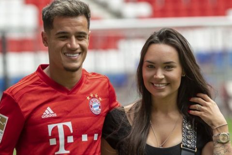 New player for Bayern Munich Philippe Coutinho poses with his wife Aina in the stadium in Munich, Germany, Monday, Aug.19, 2019. Coutinho comes as a loaner for one year from FC Barcelona. (Peter Kneffel/dpa via AP)