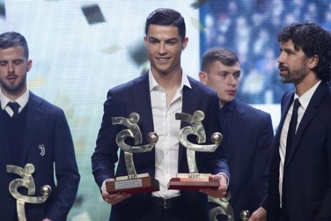 Juventus' Cristiano Ronaldo poses with the trophy for best Italian Serie A player, during the Gran Gala' soccer awards ceremony, in Milan, Italy, Monday, Dec. 2, 2019. (AP Photo/Antonio Calanni)