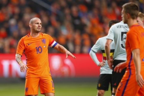 Netherlands' captain Wesley Sneijder talks to his teammates during the international friendly soccer match between Netherlands and Belgium at ArenA stadium in Amsterdam, Netherlands, Wednesday, Nov. 9, 2016. (AP Photo/Peter Dejong)