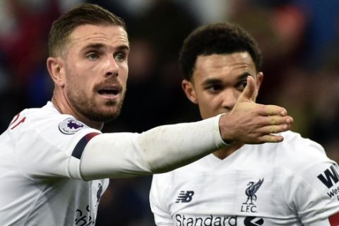 Liverpool's Jordan Henderson, left, gives instructions to his players during the English Premier League soccer match between Aston Villa and Liverpool at Villa Park in Birmingham, England, Saturday, Nov. 2, 2019. (AP Photo/Rui Vieira)