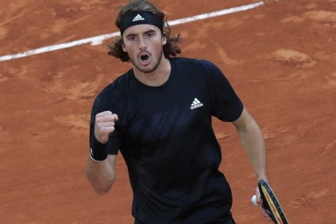Greece's Stefanos Tsitsipas clenches his fist after scoring a point against Slovenia's Aljaz Bedene in the third round match of the French Open tennis tournament at the Roland Garros stadium in Paris, France, Saturday, Oct. 3, 2020. (AP Photo/Michel Euler)