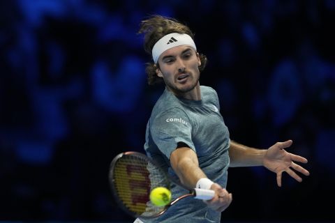 Greece's Stefanos Tsitsipas returns the ball to Italy's Jannik Sinner during their singles tennis match of the ATP World Tour Finals at the Pala Alpitour, in Turin, Italy, Sunday, Nov. 12, 2023. (AP Photo/Antonio Calanni)