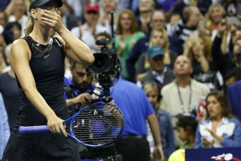 Maria Sharapova reacts after upsetting second seed Simona Halep in their opening round match in the U.S. Open tennis tournament in New York, Monday, Aug. 28, 2017. (AP Photo/Kathy Willens)