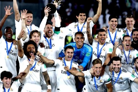Real Madrid's players celebrate with the trophy after winning the Club World Cup at Zayed Sport City in Abu Dhabi, United Arab Emirates, Saturday, Dec. 22, 2018. (AP Photo/Hassan Ammar)