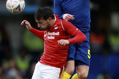 Chelsea's Jorginho jumps for the ball with Nottingham Forest's Joao Carvalho, left, during an English FA Cup third round soccer match between Chelsea and Nottingham Forest at Stamford Bridge in London, Sunday, Jan. 5, 2020. (AP Photo/Ian Walton)