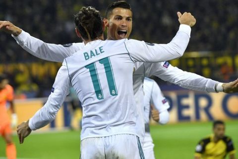 Real Madrid's scorer Cristiano Ronaldo, rear, and his teammate Gareth Bale, front, celebrate their side's 2nd goal during the Champions League group H soccer match between Borussia Dortmund and Real Madrid CF in Dortmund, Germany, Tuesday, Sept. 26, 2017. (AP Photo/Martin Meissner)