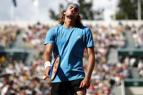 Greece's Stefanos Tsitsipas reacts after missing a shot against Switzerland's Stan Wawrinka during their fourth round match of the French Open tennis tournament at the Roland Garros stadium in Paris, Sunday, June 2, 2019. (AP Photo/Christophe Ena )