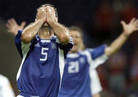 epa000224753 Greek player Traianos Dellas (front) is celebrated by team-mate Konstantinos Katsouranis (rear) at the end of the EURO 2004 semi final match between Greece and the Czech Republic at the Dragao stadium in Porto on Thursday, 01 July 2004. Greece won by a Silver Goal of Dellas.  EPA/BERND WEISSBROD NO MOBILE PHONE APPLICATIONS