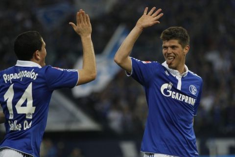 Schalke 04's Klaas-Jan Huntelaar and Kyriakos Papadopoulos (L) celebrate a goal against Bayer Leverkusen during the German first division Bundesliga soccer match in Gelsenkirchen March 24, 2012. REUTERS/Ina Fassbender (GERMANY - Tags: SPORT SOCCER) DFL LIMITS USE OF IMAGES ON THE INTERNET TO 15 PICTURES DURING THE MATCH AND, PROHIBITS MOBILE (MMS) USE DURING AND UP TO 2 HOURS POST MATCH. FOR MORE INFORMATION CONTACT DFL