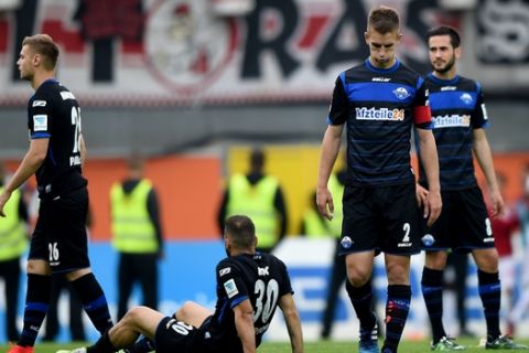 From left: Paderborn's Florian Hartherz  Suleyman Koc,  Uwe Huenemeier  and Mario Vrancic s leave the pitch after the German Bundsliga soccer match between  SC Paderborn adn VfB Stuttgart in Paderborn, western Germany, Saturday May 23, 2015.    Paderborn and Freiburg were relegated from the Bundesliga on the last day of the season Saturday, while Hamburg clinched the relegation playoff spot. (Jonas Guettler/dpa, via AP)