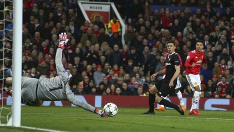 Sevilla's goalkeeper Sergio Rico make a save during the Champions League round of 16 second leg soccer match between Manchester United and Sevilla, at Old Trafford in Manchester, England, Tuesday, March 13, 2018. (AP Photo/Dave Thompson)