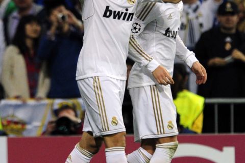 Real Madrid's French forward Karim Benzema (L) celebrates after scoring their third goal during the Champions League football match between Real Madrid and CSKA Moscow at the Santiago Bernabeu stadium in Madrid on March 14, 2012.    AFP PHOTO/JAVIER SORIANO. (Photo credit should read JAVIER SORIANO/AFP/Getty Images)