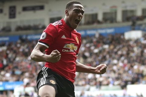 Manchester United's Anthony Martial, right, celebrates scoring his side's fourth goal with team-mate Paul Pogba, during the English Premier League soccer match between Swansea and Manchester United, at the Liberty Stadium, in Swansea, Wales, Saturday Aug. 19, 2017. (Nick Potts/ PA via AP)