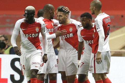 Monaco's Radamel Falcao, center, celebrates with teammates after scoring during a League One soccer match between Monaco and Lille, at the Louis II stadium, in Monaco, Sunday, May, 14 2017. (AP Photo/Claude Paris)