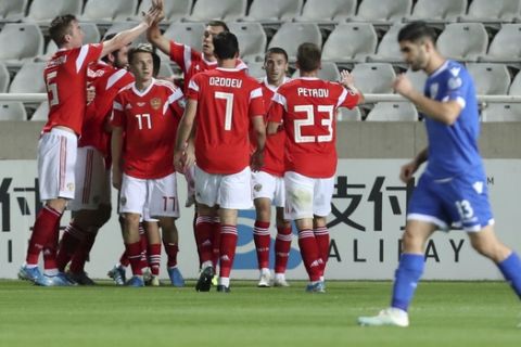 Russia's Denis Cheryshev celebrates with teammates after scoring his side's opening goal during the Euro 2020 group I qualifying soccer match between Cyprus and Russia at GSP stadium in Nicosia, Cyprus, Sunday, Oct. 13, 2019. (AP Photo/Petros Karadjias)