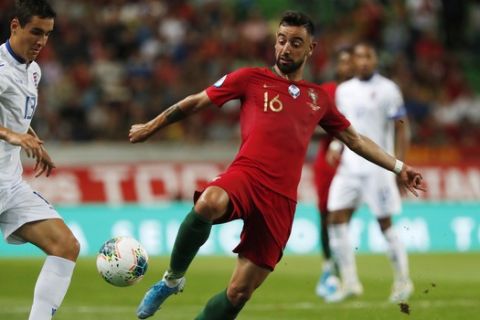 Portugal's Bruno Fernandes, right, challenges for the ball with Luxembourg's Dirk Carlson during the Euro 2020 group B qualifying soccer match between Portugal and Luxembourg at the Jose Alvalade stadium in Lisbon, Friday, Oct 11, 2019. (AP Photo/Armando Franca)
