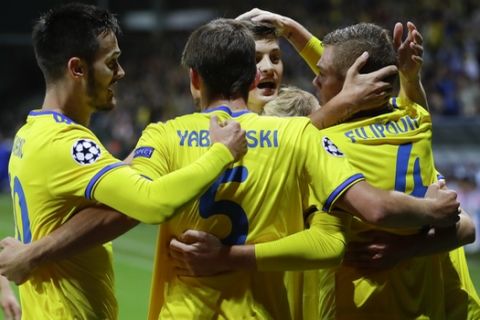 BATE's players celebrate after scoring the opening goal during the Champions League play-off round, 1st leg soccer match between Bate and PSV at the Borisov-Arena stadium in Borisov, Belarus, Tuesday, Aug. 21, 2018. (AP Photo/Sergei Grits)