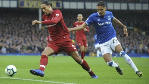 Liverpool's Virgil van Dijk, left, challenges for the ball with Everton's Dominic Calvert-Lewin during the English Premier League soccer match between Everton and Liverpool at Goodison Park in Liverpool, England, Sunday, March 3, 2019. (AP Photo/Rui Vieira)