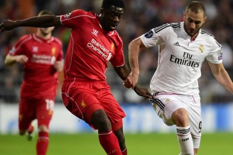 Real Madrid's French forward Karim Benzema (R) vies with Liverpool's Ivorian defender Kolo Toure during the UEFA Champions League group B football match Real Madrid CF vs Liverpool FC at the Santiago Bernabeu stadium in Madrid on November 4, 2014.  AFP PHOTO / JAVIER SORIANO        (Photo credit should read JAVIER SORIANO/AFP/Getty Images)