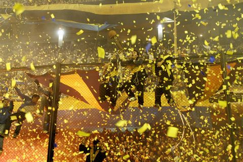Covered by yellow smoke fans of Argentina's Boca Juniors cheer their Copa Libertadores first leg soccer final game against Brazil's Gremio,at la Bombonera stadium in Buenos Aires, Wednesday, June 13, 2007.  (AP Photo/Natacha Pisarenko)