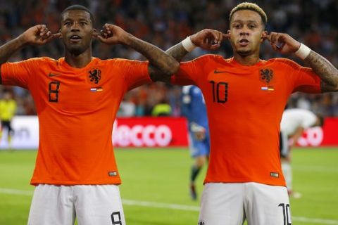 Netherland's scorer Georginio Wijnaldum, left, celebrates after he scored his side's third goal with Netherland's second scorer Memphis Depay, right, during the UEFA Nations League soccer match between The Netherlands and Germany at the Johan Cruyff ArenA in Amsterdam, Saturday, Oct. 13, 2018. The Netherlands defeated Germany with 3-0. (AP Photo/Peter Dejong)