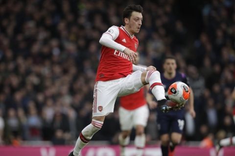 Arsenal's Mesut Ozil controls the ball during the Premier League soccer match between Arsenal and West Ham at the Emirates Stadium in London, Saturday, March 7, 2020.(AP Photo/Matt Dunham)
