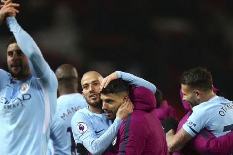 Manchester City's David Silva, center left, celebrates with teammate Sergio Aguero at the end of the English Premier League soccer match between Manchester United and Manchester City at Old Trafford Stadium in Manchester, England, Sunday, Dec. 10, 2017. City won 2-1. (AP Photo/Dave Thompson)