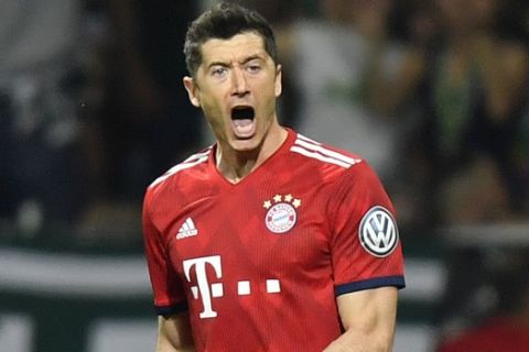 Bayern's Robert Lewandowski celebrates after scoring his side's first goal during the German soccer cup, DFB Pokal, semifinal match between Werder Bremen and Bayern Munich at the Weser stadium in Bremen, Germany, Wednesday, April 24, 2019. (AP Photo/Martin Meissner)