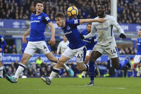 Everton's Jonjoe Kenny, centre and Chelsea's Tiemoue Bakayoko battle for the ball, during the English Premier League soccer match between Everton and Chelsea, at Goodison Park, in Liverpool, England, Saturday Dec. 23, 2017. (Peter Byrne/PA via AP)