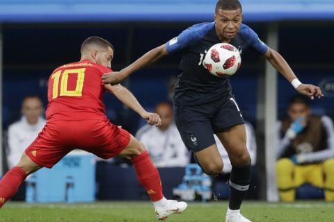 Belgium's Eden Hazard, left, challenges France's Kylian Mbappe during the semifinal match between France and Belgium at the 2018 soccer World Cup in the St. Petersburg Stadium, in St. Petersburg, Russia, Tuesday, July 10, 2018. (AP Photo/Petr David Josek)