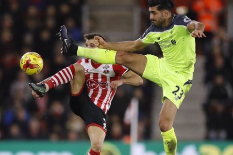 Southampton's Cedric, left, and Liverpool's Emre Can challenge for the ball during the English League Cup semifinal first leg soccer match between Southampton and Liverpool at St. Mary's stadium in Southampton, England, Wednesday, Jan. 11, 2017. (AP Photo/Frank Augstein)