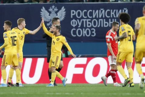Belgium's Thorgan Hazard, left, celebrates with teammates after scoring his side's opening goal during the Euro 2020 group I qualifying soccer match between Russia and Belgium, at Gazprom Arena in St. Petersburg, Russia, Saturday, Nov. 16, 2019. (AP Photo/Dmitri Lovetsky)